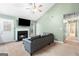 Cozy living room showcasing a fireplace, a large screen tv, and access to the kitchen at 470 Old Griffin Rd, Hampton, GA 30228