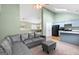 Open-concept living room with vaulted ceilings and a modern gray sofa at 470 Old Griffin Rd, Hampton, GA 30228