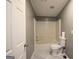 Bathroom view showing the shower/tub, toilet, and gray walls with white trim at 208 Holliday Way, Carrollton, GA 30116