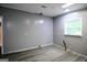 Empty bedroom with gray walls, hardwood floors, and a single window at 208 Holliday Way, Carrollton, GA 30116