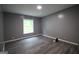 Simple empty bedroom with gray walls, hardwood floors, and one window at 208 Holliday Way, Carrollton, GA 30116