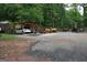 Open driveway with a covered parking spot for one car and several pieces of construction equipment at 208 Holliday Way, Carrollton, GA 30116
