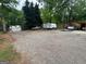Wide gravel driveway offering parking space for multiple vehicles and an RV at 208 Holliday Way, Carrollton, GA 30116
