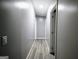Hallway with hard surface flooring and neutral colored walls at 208 Holliday Way, Carrollton, GA 30116