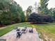 Secluded backyard oasis featuring a firepit area with comfortable seating, creating an ideal setting for outdoor gatherings at 3550 N Bogan Rd, Buford, GA 30519