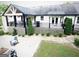 Well-manicured backyard with patio, lush landscaping, and an elevated deck at 3550 N Bogan Rd, Buford, GA 30519