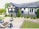 The backyard features a spacious patio with a fire pit, wooden chairs, and well-kept landscaping at 3550 N Bogan Rd, Buford, GA 30519
