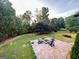 An overhead view of the backyard firepit with mature trees in the background at 3550 N Bogan Rd, Buford, GA 30519