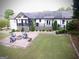 Expansive backyard boasts a beautiful brick patio with a charming fire pit and lush greenery at 3550 N Bogan Rd, Buford, GA 30519