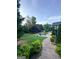 A brick path in backyard leads to a firepit with mature trees in background at 3550 N Bogan Rd, Buford, GA 30519