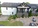 An aerial view of backyard with lush landscaping, an elevated porch, and an attached two-car garage at 3550 N Bogan Rd, Buford, GA 30519