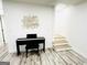 Bright basement features a piano and stairs with white walls and light wood-look floors at 3550 N Bogan Rd, Buford, GA 30519