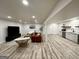 Bright basement with living area, kitchenette, and modern wood-look flooring at 3550 N Bogan Rd, Buford, GA 30519