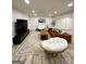 Spacious basement with living area, lounge seating, and light wood-look flooring at 3550 N Bogan Rd, Buford, GA 30519