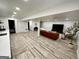 Finished basement features a living area, piano, kitchenette, and modern flooring at 3550 N Bogan Rd, Buford, GA 30519