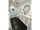 Bathroom featuring a stand-up glass shower, black hexagonal tile floor, and vanity with modern black hardware at 3550 N Bogan Rd, Buford, GA 30519