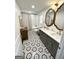 Bright bathroom featuring a double vanity, stylish mirrors, and hexagon tile flooring at 3550 N Bogan Rd, Buford, GA 30519