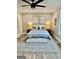 Comfortable bedroom with a ceiling fan, large bed, neutral color scheme, and natural lighting at 3550 N Bogan Rd, Buford, GA 30519