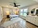 Bright bedroom with a view, a ceiling fan, a comfortable bed, and a dresser for storage at 3550 N Bogan Rd, Buford, GA 30519