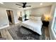 Bedroom featuring a ceiling fan, an ensuite bathroom, a comfortable bed, and lots of natural light at 3550 N Bogan Rd, Buford, GA 30519