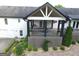 View of covered deck with patio furniture and hanging flower baskets at 3550 N Bogan Rd, Buford, GA 30519