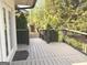 Covered deck boasts views of manicured landscaping, offering the perfect spot for outdoor relaxation and entertaining at 3550 N Bogan Rd, Buford, GA 30519