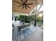 A well-designed covered patio featuring comfortable furniture, a ceiling fan, and a verdant backyard view at 3550 N Bogan Rd, Buford, GA 30519