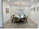 Bright dining room featuring a modern chandelier and a large window overlooking a private outdoor space at 3550 N Bogan Rd, Buford, GA 30519