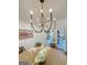 Elegant dining room featuring a modern chandelier, wood table, and access to outdoor patio at 3550 N Bogan Rd, Buford, GA 30519