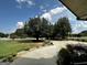 Expansive driveway surrounded by lush landscaping and mature trees, perfect for outdoor activities at 3550 N Bogan Rd, Buford, GA 30519