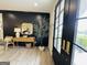 Stylish foyer features black french doors, wood-look flooring, and a decorative tree, creating a welcoming entrance at 3550 N Bogan Rd, Buford, GA 30519