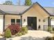 Inviting front entrance features black double doors, fresh landscaping, and a neutral exterior color palette at 3550 N Bogan Rd, Buford, GA 30519
