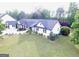 Charming white farmhouse-style home with a lush green lawn and manicured landscaping at 3550 N Bogan Rd, Buford, GA 30519