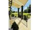 Relaxing covered front porch with black railing and columns overlooking the manicured front yard at 3550 N Bogan Rd, Buford, GA 30519