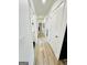 Hallway with wood grain flooring leading past multiple rooms at 3550 N Bogan Rd, Buford, GA 30519