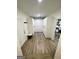 Hallway featuring stylish wood flooring, ample closet space, and access to other areas of the home at 3550 N Bogan Rd, Buford, GA 30519