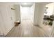 Hallway with custom built in cabinets, built in bench on woodgrain flooring, leading to the living room at 3550 N Bogan Rd, Buford, GA 30519