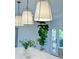 Contemporary kitchen with island featuring statement lighting, white marble counters and a large fiddle leaf fig at 3550 N Bogan Rd, Buford, GA 30519