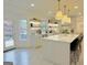 Modern kitchen featuring white cabinets, an island with bar stools, stainless steel appliances, and an outdoor deck at 3550 N Bogan Rd, Buford, GA 30519