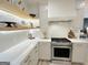 Bright kitchen with white cabinets, open shelving, and stainless steel appliances, offering a modern and functional space at 3550 N Bogan Rd, Buford, GA 30519