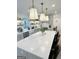Bright kitchen features a large center island with white marble countertop, farmhouse sink, and pendant lighting at 3550 N Bogan Rd, Buford, GA 30519