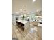 Modern kitchen features stainless steel appliances, white cabinetry, a large island, and ample counter space at 3550 N Bogan Rd, Buford, GA 30519