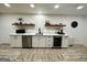 Basement kitchenette features white cabinets, stainless appliances, and stylish accents at 3550 N Bogan Rd, Buford, GA 30519