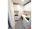 Well-lit laundry room with modern washer and dryer, ample cabinet space, and stylish patterned flooring at 3550 N Bogan Rd, Buford, GA 30519