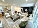 Bright living room features a large sectional sofa, stylish decor, and plank flooring at 3550 N Bogan Rd, Buford, GA 30519