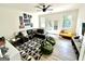 Spacious living room featuring a black leather sectional sofa, fun wall decor, and ample natural light at 3550 N Bogan Rd, Buford, GA 30519