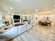 Open-concept living room with a fireplace, modern furniture, and seamless flow to the dining area and kitchen at 3550 N Bogan Rd, Buford, GA 30519