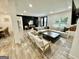 Spacious living room featuring a large sectional sofa, wood floors, and stylish decor at 3550 N Bogan Rd, Buford, GA 30519
