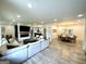 Open-concept living room with a fireplace, flat screen TV, dining area, and kitchen at 3550 N Bogan Rd, Buford, GA 30519