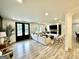 Open-concept living room featuring modern decor, a fireplace, a flat screen TV, a dining area, and an open kitchen at 3550 N Bogan Rd, Buford, GA 30519